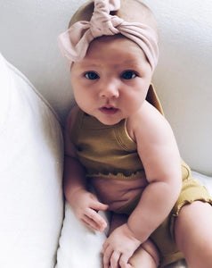 baby in a blush headband